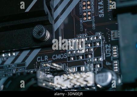 Macro close up of modern motherboard PCB with MOSFET components and semiconductor circuitry desktop computer hardware technology Stock Photo