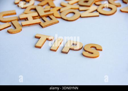 Tips text formed with wooden letters on white background representing advice guidance and helpful information concept Stock Photo