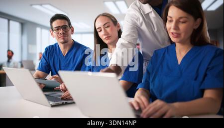 Medical Students Engage In Lesson With Healthcare Consultant In Classroom Setting. Stock Photo
