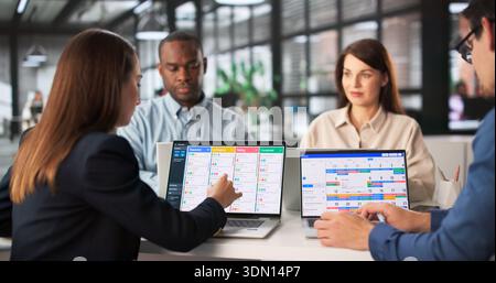 Multiracial Team Plans Schedule Using Kanban And Gantt Software. Stock Photo