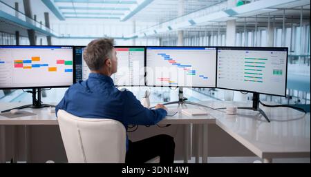 Businessman Using Scheduling Software To Manage Events And Reports Efficiently. Stock Photo