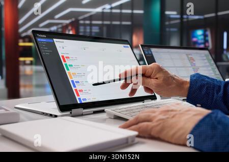Tech Support Specialist Upgrading Software And Monitoring Ticket System Remotely Stock Photo