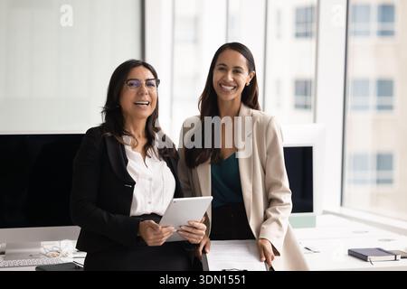 Portrait of diverse team members posing in modern coworking office Stock Photo