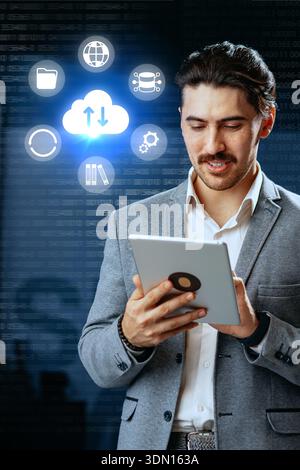 Businessman using tablet for cloud technology and data management in a modern office setup Stock Photo