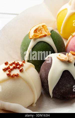Cakes are displayed on a plate at a dessert shop in the daylight Stock Photo