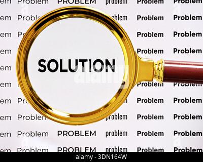 Problem solving, finding answers, searching for a solution. Magnifying glass highlighting the word SOLUTION among many PROBLEM words, Stock Photo