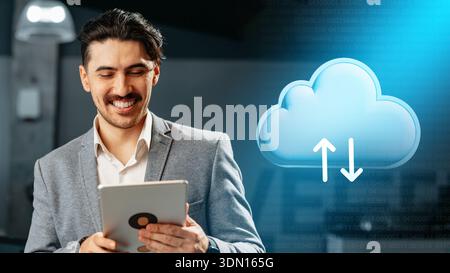 Man using tablet to manage data storage in cloud computing environment at modern office Stock Photo