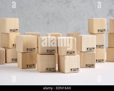 Wooden blocks stacked and arranged, displaying standard shipping symbols. Concept of logistics, global supply chain, and delivery network Stock Photo