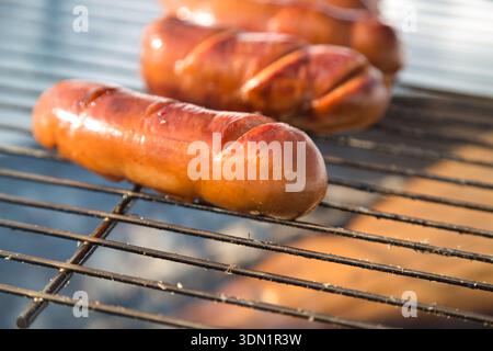 Grilled sausages on a barbecue grill in Hasliberg, Switzerland. Stock Photo