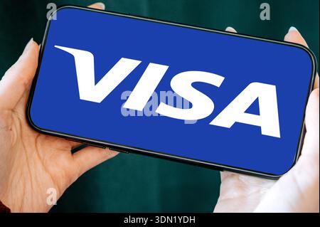 Riga, Latvia - February 04, 2026:Close-up of a smartphone held in hands displaying the Visa logo on the screen. Concept of digital payments, mobile ba Stock Photo