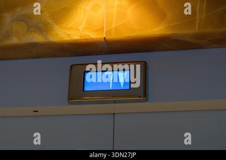 Elevator floor indicator display showing number seven and arrow Stock Photo