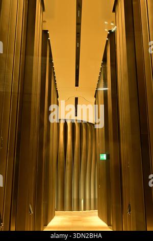Futuristic golden metallic hallway with sculptural waves and symmetry Stock Photo