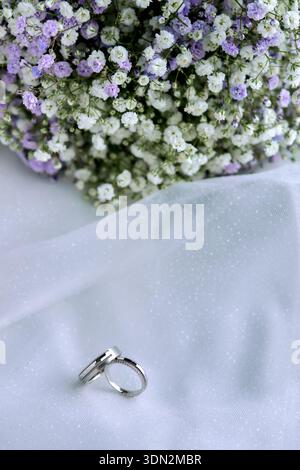 Elegant wedding arrangement with flowers and rings Stock Photo