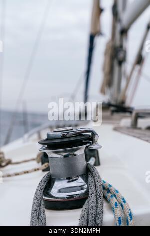 Sailboat winch and rope on deck navigating ocean Stock Photo