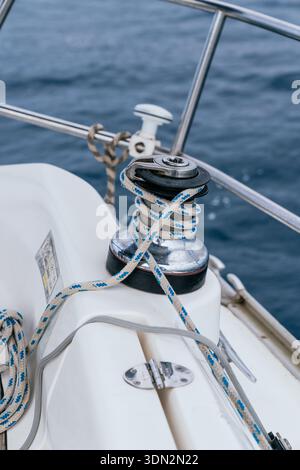 Sailing yacht winch with rope on deck Stock Photo