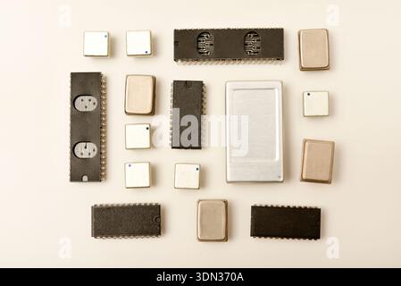 Old chips on a white background. Electronic components. Processors in metal and plastic cases. Stock Photo