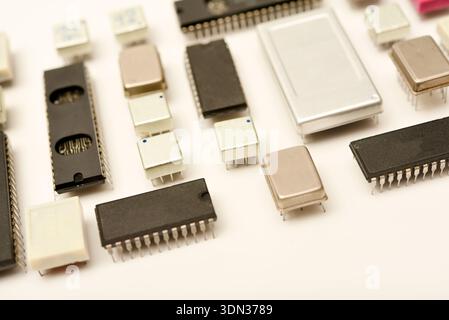 Old chips on a white background. Electronic components. Processors in metal and plastic cases. Stock Photo