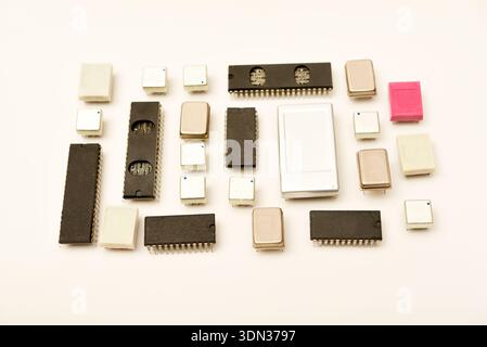 Old chips on a white background. Electronic components. Processors in metal and plastic cases. Stock Photo