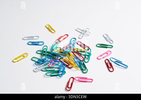 colored paper clips on a white background Stock Photo