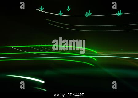 Smooth green glowing light waves forming abstract motion lines on a dark futuristic technology background Stock Photo
