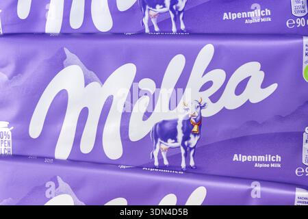 Stuttgart, Germany - September 18, 2025: Milka chocolate 90g bar Alpine milk background close-up with company logo in Stuttgart, Germany. Stock Photo