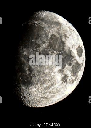 Detailed close-up of the Moon showing craters and surface texture against a dark sky. Stock Photo
