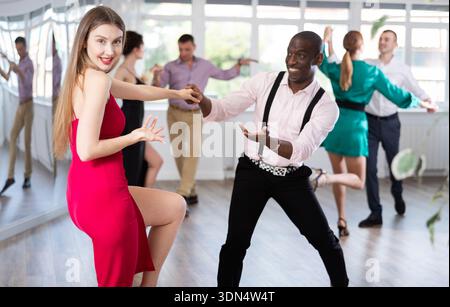 Man and woman practicing swing dance in dancing studio Stock Photo