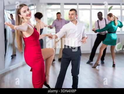 Man and woman practicing swing dance in dancing studio Stock Photo