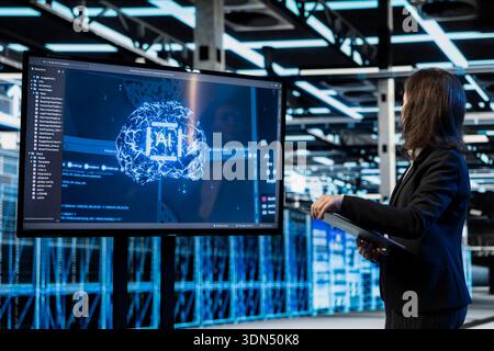 Artificial intelligence AR visualization used by server hub programmer to do gear maintenance. Female engineer monitoring AI neural network data center rigs with display, holographic VFX compositing Stock Photo