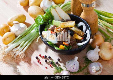 Delicious salad with chicken hearts, peach, pear, quail eggs and grilled cheese Stock Photo