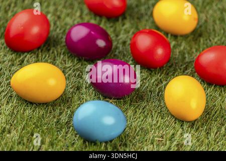Colourful Easter eggs spread on green grass Stock Photo