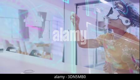 Reaching man wearing yellow tee white VR headset interacting with HUD at office, copy space Stock Photo