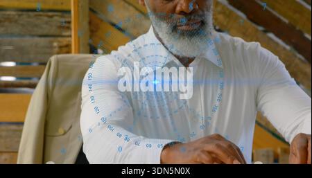 Sitting man in white shirt placing hands on wooden table in rustic loft, viewing blue HUD Stock Photo