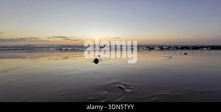 Evening on the beach with soft waves and peaceful horizon, Morocco Stock Photo