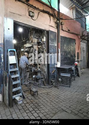 A well-stocked workshop full of cables and tools in a medina, Morocco Stock Photo