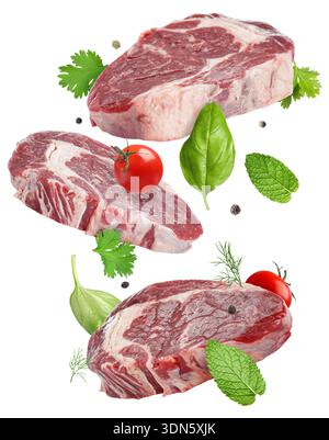 Fresh beef steaks falling on white background Stock Photo
