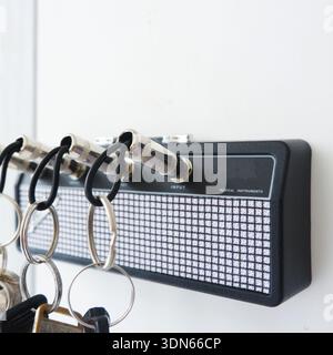 Creative Guitar Amp Key Holder with Jack Plug Keychains on White Wall Stock Photo