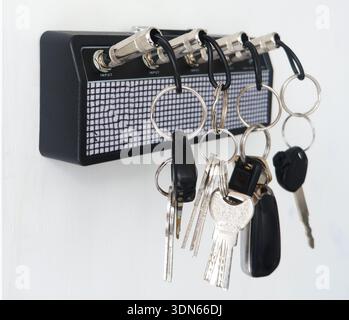 Creative Guitar Amp Key Holder with Jack Plug Keychains on White Wall Stock Photo