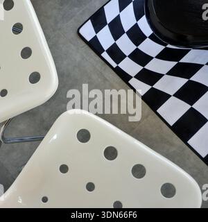 Top View of Modern Interior with Black Leather Sofa and Checkered Rug Stock Photo