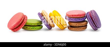 Row of colorful assorted macarons isolated on white background, french sweets Stock Photo