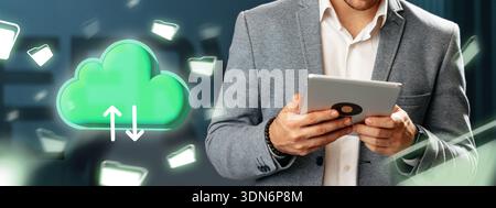 Man holding tablet while using cloud storage service on modern background in office setting Stock Photo