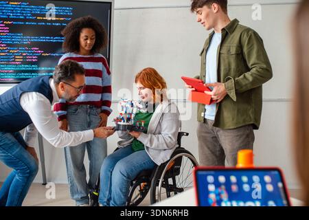 Inclusive student team presenting technology project in class. Stock Photo