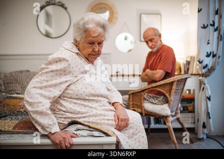 Elderly spouses sharing quiet moment before sleep. Stock Photo