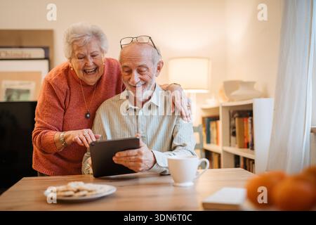 Senior coule working with tablet, having problem with technology. Stock Photo