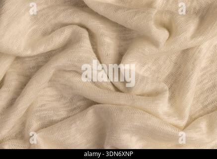 natural cotton fabric with tightly intertwined threads for making garments, light-colored fabric for sewing sweatshirts, T-shirts and other clothing Stock Photo