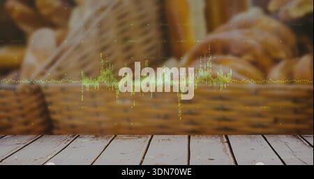 Displaying digital green waveform overlaying worn tabletop at bakery, with wicker baskets behind Stock Photo