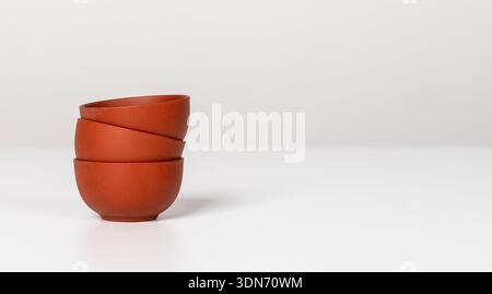 Stack of three small ceramic cups, bowls on table. Banner background with kitchen ware. Banner background Stock Photo