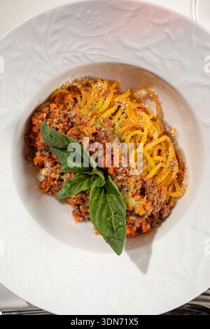 Spaghetti bolognese with basil in white plate Stock Photo
