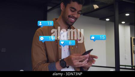 Smiling adult man using phone in office in brown shirt and watch, seeing notification counters Stock Photo