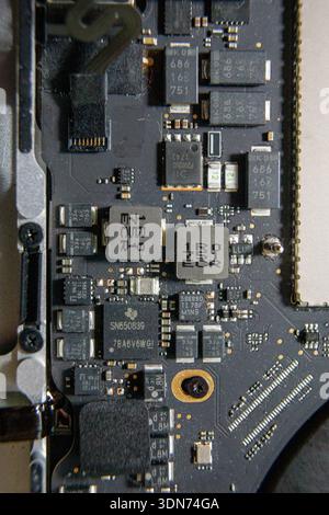 Close-up of power control chips and surface mounted components on an electronic circuit board. Stock Photo